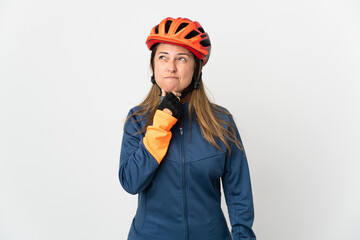 Middle age cyclist woman isolated on white background having doubts and thinking