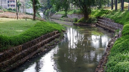 Fototapeta na wymiar a small river that divides a garden