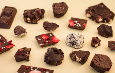 pattern of many pieces of different chocolate, handmade craft chocolates broken into pieces
