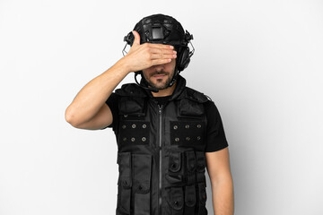 Young caucasian swat isolated on white background covering eyes by hands. Do not want to see something