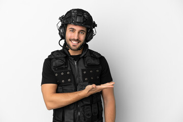 Young caucasian swat isolated on white background presenting an idea while looking smiling towards