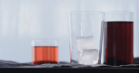 making cocktail aperetivo in tumbler glass with window on background