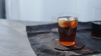 making cocktail aperetivo in tumbler glass with window on background