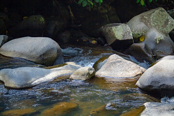 Naklejka na ściany i meble Big rocks background in the river in the forest