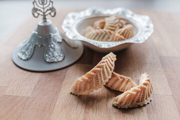 Homemade sweets from gazelle horns for Ramadan. Close-up detail shot of fresh baked Kaab El Ghazal,...