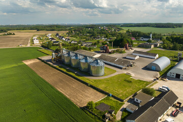 aerial view on agro silos granary elevator on agro-processing manufacturing plant for processing drying cleaning and storage of agricultural products, flour, cereals and grain.
