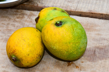 Fresh mango on the background of a wooden table