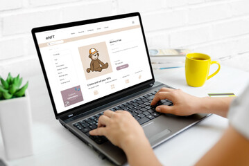 Buying NFT art on the web market concept. Modern website on laptop with trend NFT monkey art....