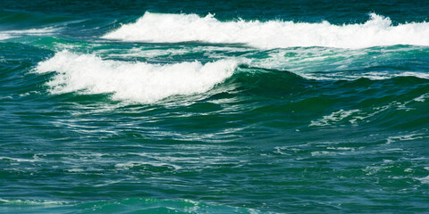 abstract sea background. green wave close up. blurry water in evening light