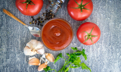 Ketchup in a bowl on the table. Selective focus.