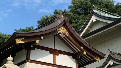 Fototapeta na wymiar The rooftop gold emblem decor of ancient Japanese shrine house, Ueno park Gojyoten Jinjya” temple, year 2022 sunny weekday 