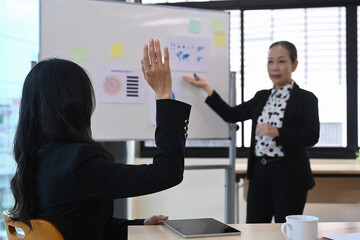 Female team leader explaining project details, discussing for new strategy of development at corporate meeting