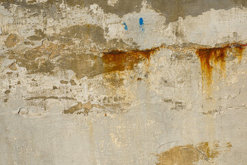 Old dirty concrete wall with traces of rust.