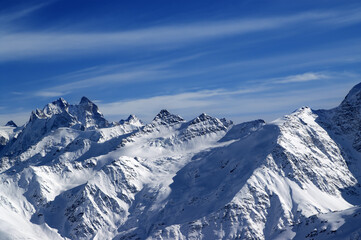 Fototapeta na wymiar Snowy sunlight mountains, view from ski slope