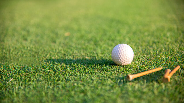 Golf ball on tee on golf course. Hobby in holiday and vacations on club golf. Lifestyle and Sport Concept