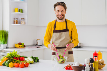 Photo of young handsome man prepare fresh vegetables ingredient nutrition healthy tasty supper indoors