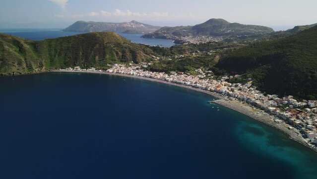 Aeolian Islands. Lipari town aerial view with drone overlooking to other islands: Hovering on Lipari city centre, Lipari's castle and Canneto's beach