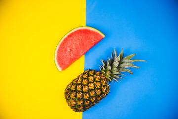 Watermelon and pineapple on pastel yellow and blue backgrounds - Powered by Adobe