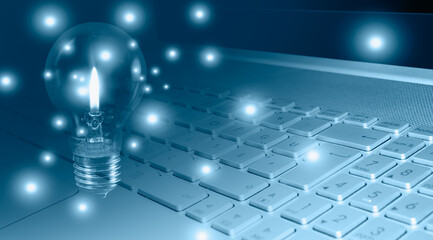 Idea concepts - Computer notebook or laptop with light bulb