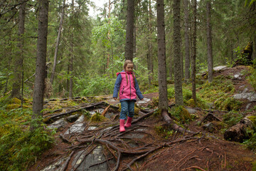 Little girl scout during hiking in autumn forest