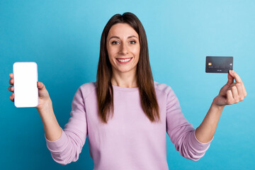 Naklejka premium Photo of young pretty woman show mobile credit card benefit app download cashback isolated over blue color background