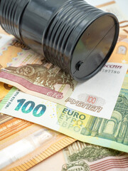 euro banknotes and russian ruble and oil barrel concept photo	