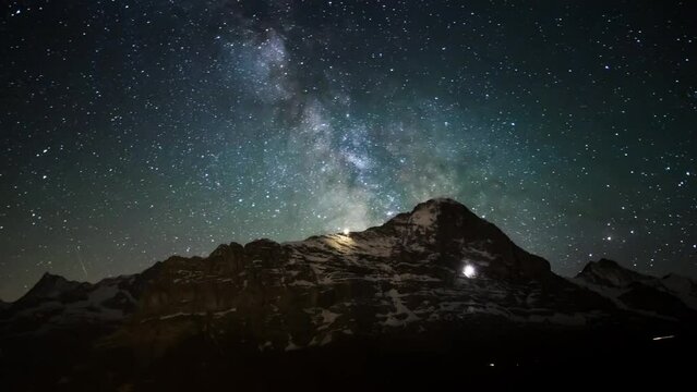 Timelapse of milky way and stars in a wonderful summer night above the Eiger North Face in Grindelwald with Mount Finsteraarhorn and Jungfrau surrounding the Eiger.