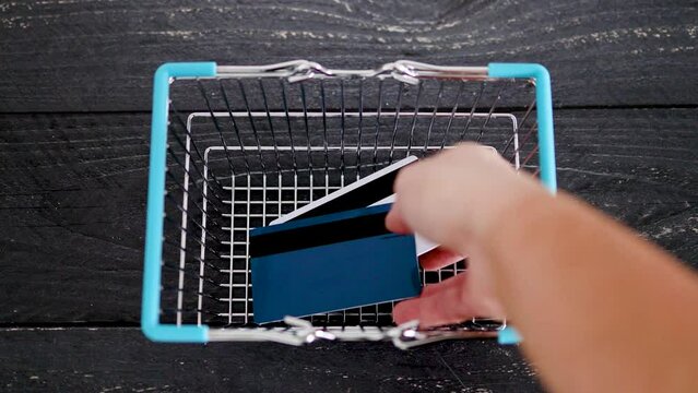 economy after covid,  hand placing inflation shortages and recession texts inside shopping basket