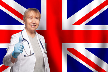UK smiling mature doctor with stethoscope on flag of United Kingdom background