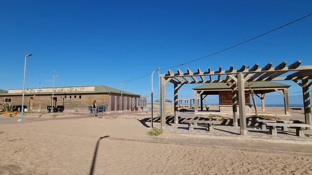 Girl with long hair walks on a lonely street in Casa del mar, Tarfaya,, Marroco. 4K videos