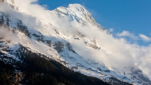 timelapse of clouds at the Eiger North Face in Grindelwald, Switzerland, after a fresh snow fall at high altitudes.