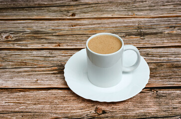 Coffee cup on wooden table.
