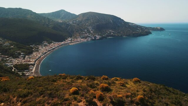 Aeolian Islands. Lipari town aerial view with drone overlooking to other islands: Hovering on Lipari city centre, Lipari's castle and Canneto's beach