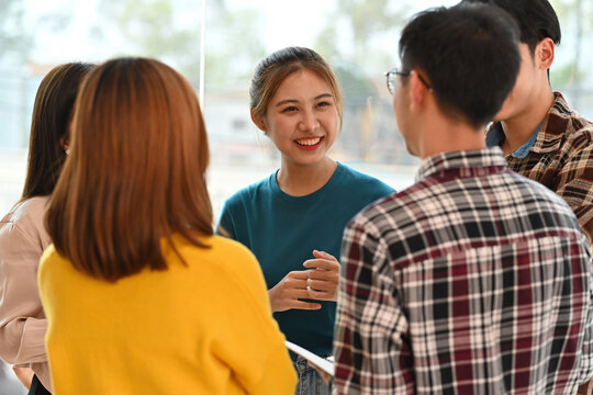 Asian business female smiling diverse colleagues gather in boardroom brainstorm discuss financial statistics togethe at office meeting. Teamwork concept. Business and financial meeting.