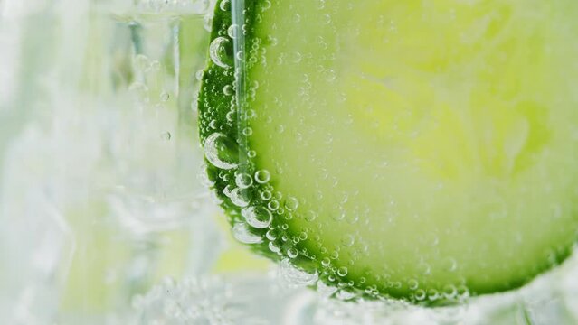 Lemonade with Cucumber and rosemary texture. Gin tonic cocktail close-up macro, healthy drink. Detox drinking, summer refreshment concept.
