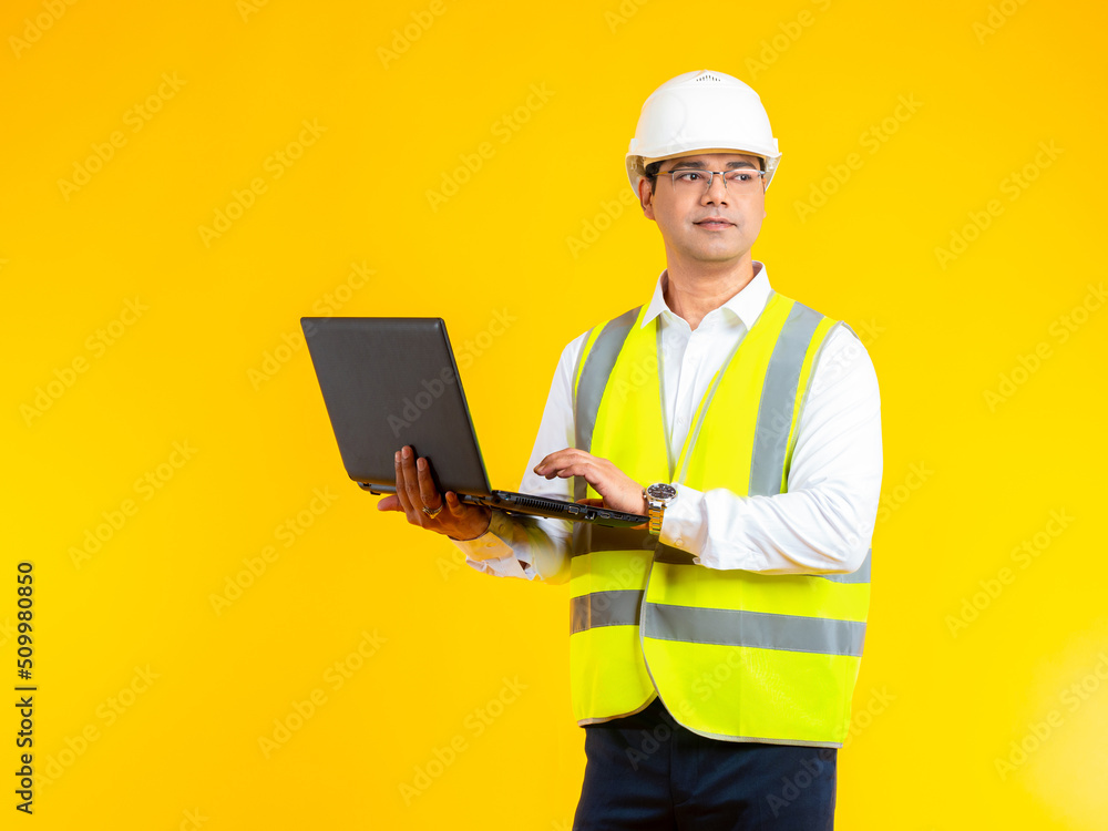 Aufkleber man builder. young builder in reflective jacket. construction company engineer. man stands with lapt