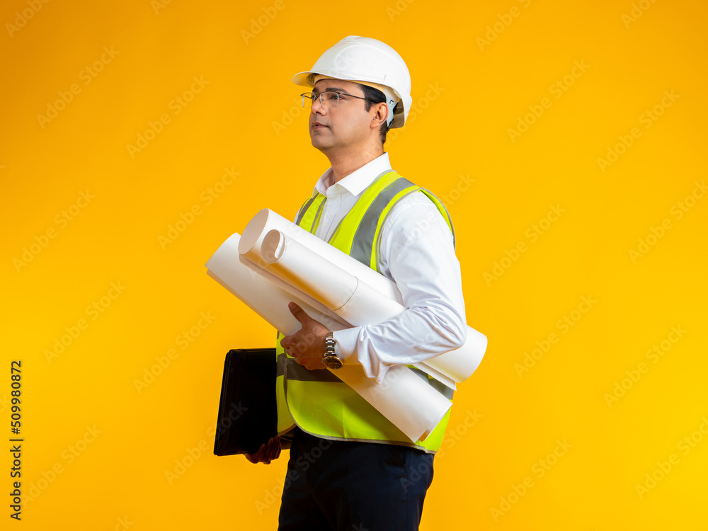 Aufkleber man architect. young indian architect. guy with drawings in hands on yellow. architect is hold const