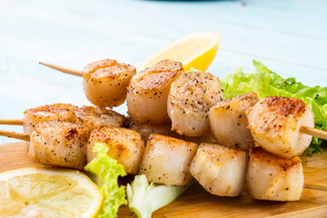 Scallops on skewers close-up. Grilled sea scallops.