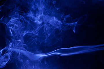 Blue smoke on a black background.
