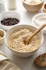 Oat flakes, old fashion close up oat flakes in a bowl. Chocolate oats brownies ingredients, cooking pastry, muffins, baking dessert