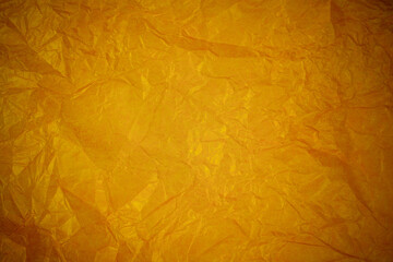 Crumpled gold paper recycling background.