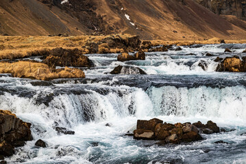 Close-up of the cascade of the beautiful Fossálar waterfall in late winter, situated right next to the Ring Road / Route 1, not far from Kirkjubæjarklaustur, Southern Region, Iceland