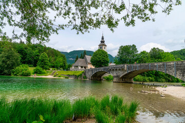 Bohinj Lake, Church of St John the Baptist with bridge. Triglav National Park, Julian Alps, Slovenia.