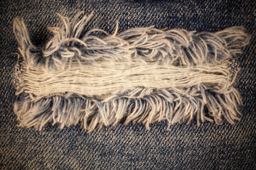 Vintage torn denim jeans texture.