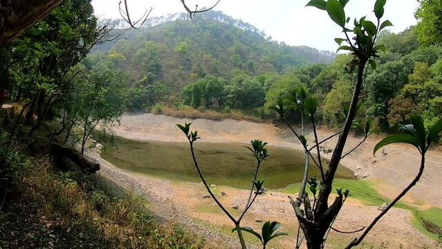 Half-dried out pond among hills of Uttarakhand, time lapse