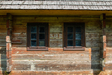 Fototapeta na wymiar A wooden house, an old historic structure. A beautiful, intimate, wooden house in the Carpathians, Poland. Historic wooden building. A house that smells like a forest