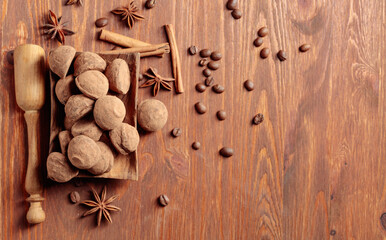 Chocolate truffles on a wooden table.