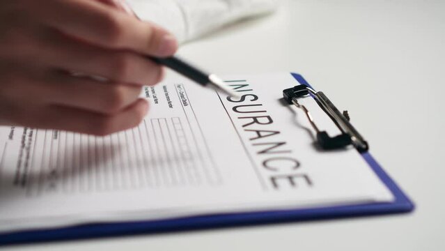 Filling out an insurance form, completing documentation for property life insurance, consulting an appointment with an insurance agent who shows documents for registration
