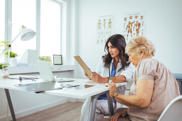 Cropped shot of an attractive young female doctor consulting with a patient inside her office at a hospital. Female doctor looking at test results of her patient. 