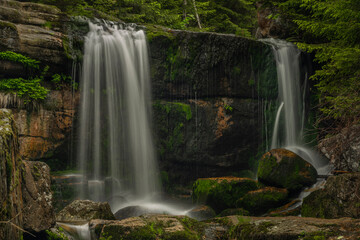 Obraz premium Waterfall of Jedlova creek in Jizerske mountains in spring morning